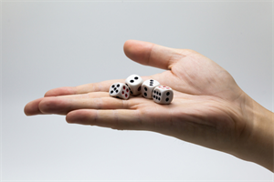Person's hand holding several dice that are about to be rolled