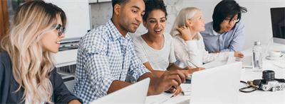 Coworkers using Microsoft Office 2019 products on laptops